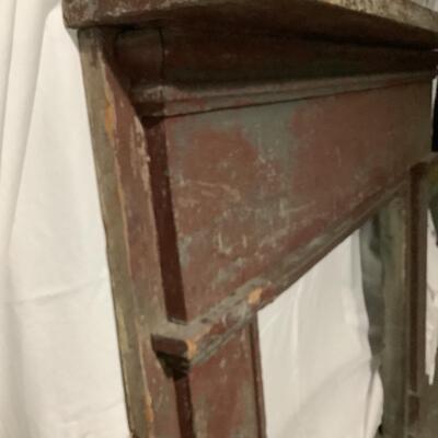Mantel surround -aged wood from the ages with darker red paint