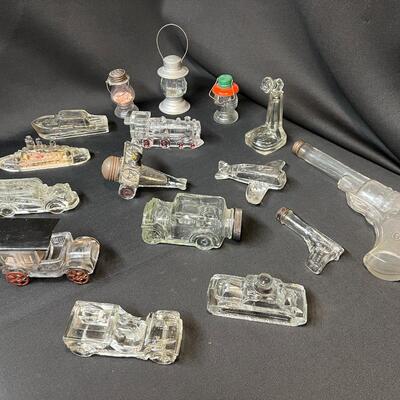 Lot of 16 Antique Glass Candy Jars Shaped Like Cars, Tank, Planes, Boats, Train, Guns, Telephone, and Lanterns