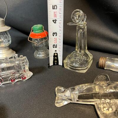 Lot of 16 Antique Glass Candy Jars Shaped Like Cars, Tank, Planes, Boats, Train, Guns, Telephone, and Lanterns