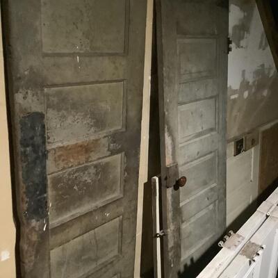 2 grayish old doors, 6 panels, old-fashioned door knob