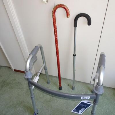 LOT 552. WALKER AND TWO CANES