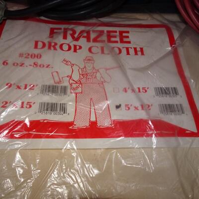 LOT 589. TWO DROP CLOTHS IN PACKAGE AND EXTENSION CORDS