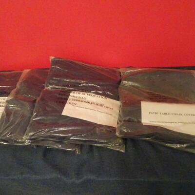 LOT 612. FOUR PATIO CHAIR COVERS