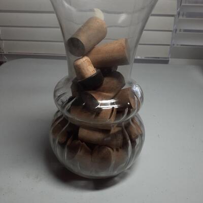 9in tall vase with assorted corks