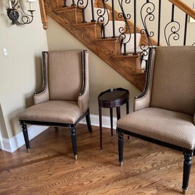 Two elegant high end arm chairs and a side table