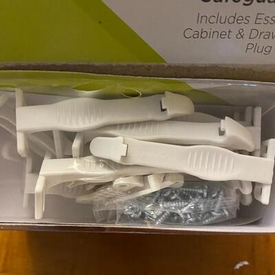open package of child cabinet locks and plug protectors