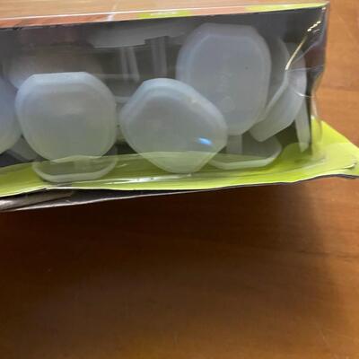 open package of child cabinet locks and plug protectors