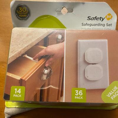 open package of child cabinet locks and plug protectors