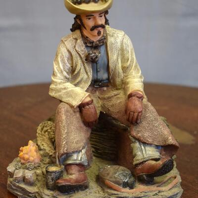 Cowboy on log statue