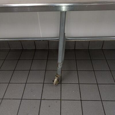 STAINLESS STEEL TABLE ON CASTORS