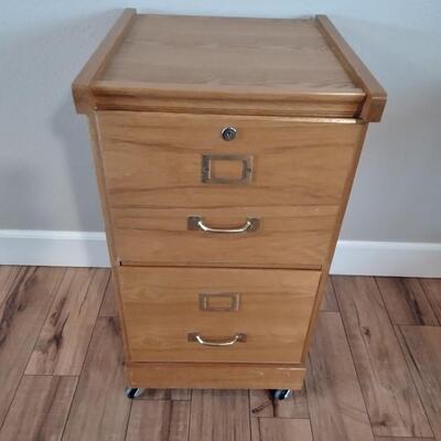 LOT 7 WOOD FILING CABINET WITH KEYS ON CASTERS