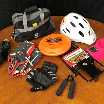 sports equipment: rawlings baseball glove, frisbee, helmet, standard bike rack, batters gloves, umbrella, nike hat and bag;