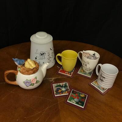 glassware : teapot,coffee mugs, coasters, cookie jar featuring vintage comic scenes;