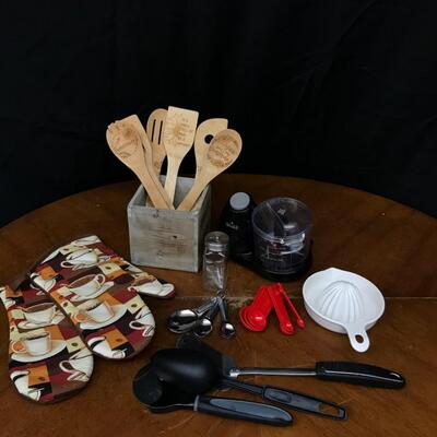 kitchen: oven mitts, measuring spoons,wooden set with box of various spatulas;