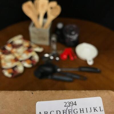 kitchen: oven mitts, measuring spoons,wooden set with box of various spatulas;