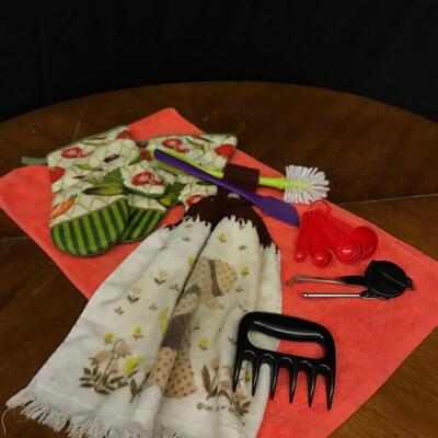 kitchen: oven mittens oven hanging crocheted hand towel, grater, can opener, measuring spoons, sponge brush;