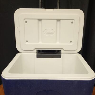 :1 Coleman Blue cooler, white lid on wheels;