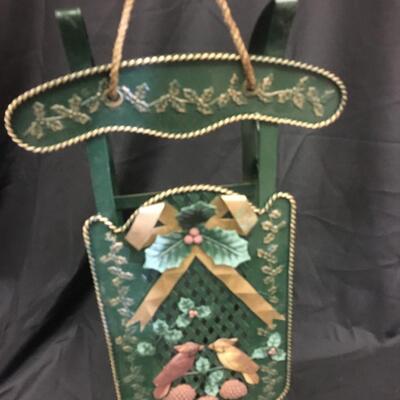 : Green metal decorative sleigh;