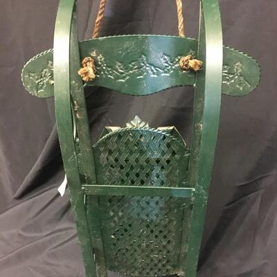 : Green metal decorative sleigh;
