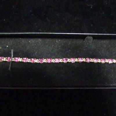 LOT 65  14K LADIES BRACELET WITH PINK STONES