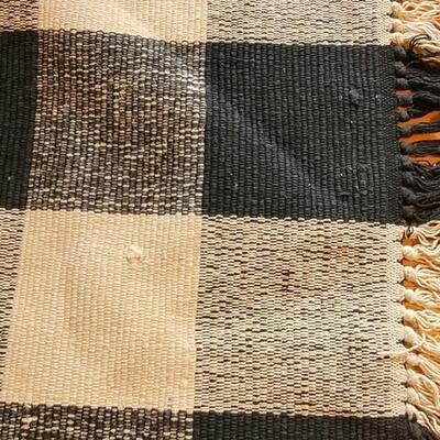 Lot 193: Black and Tan Buffalo Check Woven Rug | EstateSales.org