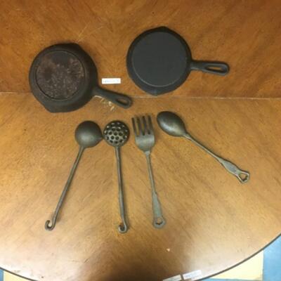 : Cast Iron Lot; 4 large untencils; 2 skillets;