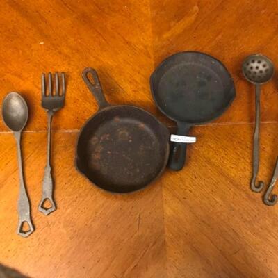 : Cast Iron Lot; 4 large untencils; 2 skillets;