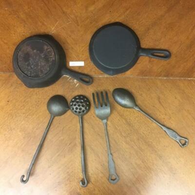 : Cast Iron Lot; 4 large untencils; 2 skillets;