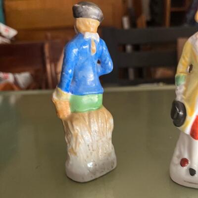 Antique colonial dressed men shaker set