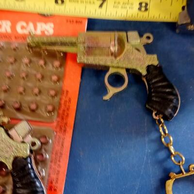 LOT 16   NINE VINTAGE CAP GUN KEY CHAINS WITH CAPS