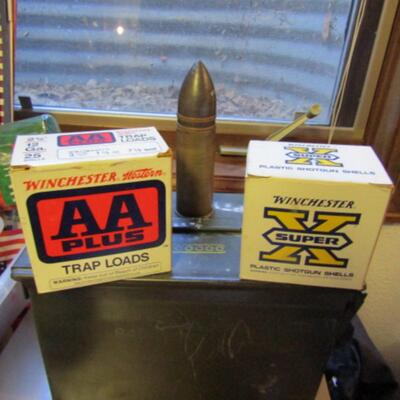 LOT 79  TWO BOXES OF SHOT GUN SHELLS AND A LARGE BULLET