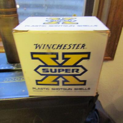 LOT 79  TWO BOXES OF SHOT GUN SHELLS AND A LARGE BULLET