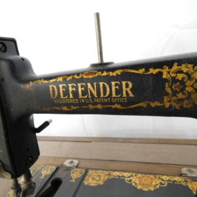 Antique Cast Body Defender Sewing Machine in Oak Cabinet with Foot Treadle
