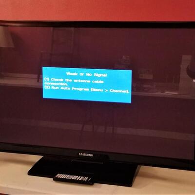 Lot #242  SAMSUNG 43" Flat Screen tv with stand and remote