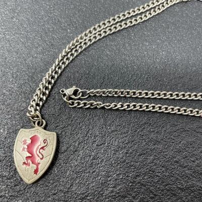 LION SHIELD NECKLACE W/ INSCRIPTION FROM â€œTHE CHRONICLES OF NARNIAâ€