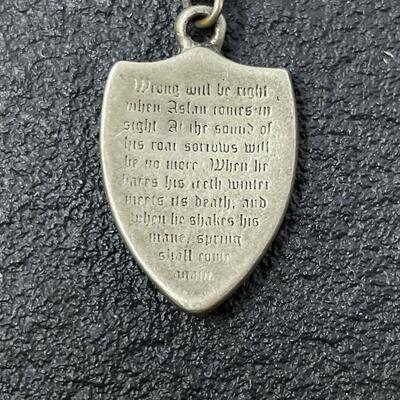 LION SHIELD NECKLACE W/ INSCRIPTION FROM â€œTHE CHRONICLES OF NARNIAâ€