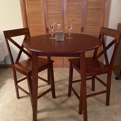 Bistro style table & chairs. Mahogany stain drop-leaf table, bar height, and two chairs