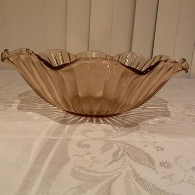 Pink depression glass bowl with ridges and ruffled edge