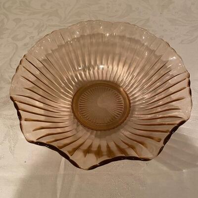 Pink depression glass bowl with ridges and ruffled edge