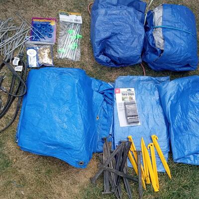 LOT 110  FIVE TARPS, STAKES, BUNGEE CORDS AND GROMMETS