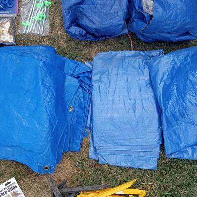 LOT 110  FIVE TARPS, STAKES, BUNGEE CORDS AND GROMMETS