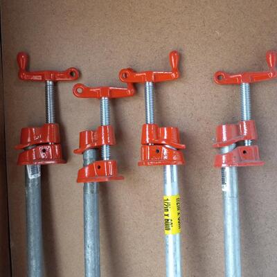 LOT 48  FOUR PIPE CLAMPS AND 3 PIPES
