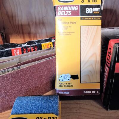 LOT 35  NEW ANGLE GRINDER, BELT SANDPAPER, BOX CUTTERS AND MORE
