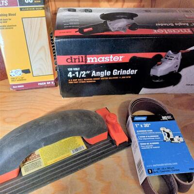 LOT 35  NEW ANGLE GRINDER, BELT SANDPAPER, BOX CUTTERS AND MORE