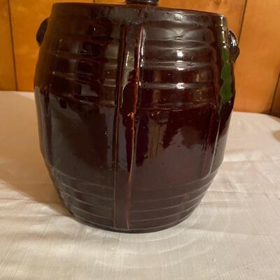 Old brown pottery crock with lid