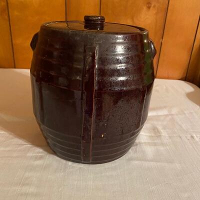 Old brown pottery crock with lid
