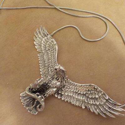Sterling silver Eagle attacking a snake/ wings move. Necklace.