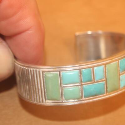 Sterling silver Bracelet curb with green stone inlay.