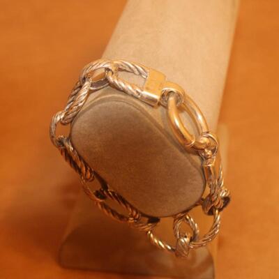 Sterling silver open curve link bracelet.