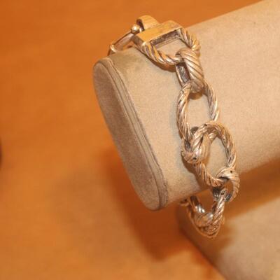 Sterling silver open curve link bracelet.